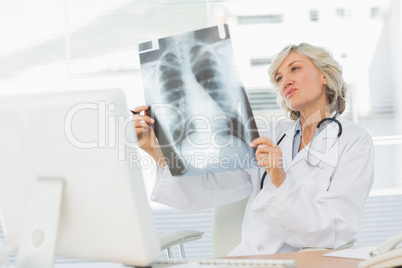 Female doctor examining x-ray in medical office