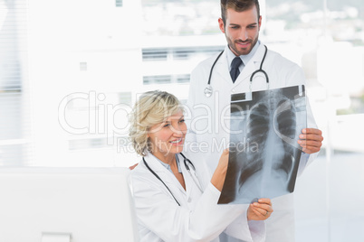 Doctor explaining x-ray to her male colleague