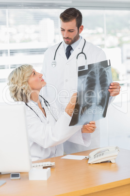 Doctor explaining x-ray to her male colleague