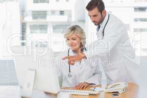 Doctors using computer at medical office