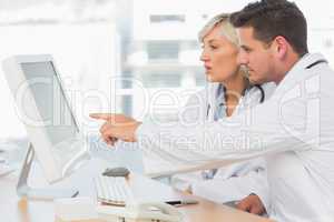 Doctors using computer at medical office