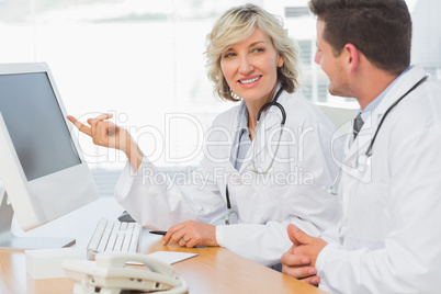 Doctors using computer at medical office