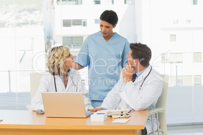 Three concentrated doctors in discussion