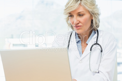 Female doctor using laptop in medical office