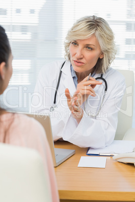 Female doctor listening to patient with concentration