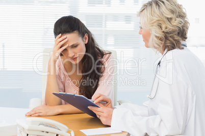 Female doctor discussing reports with patient