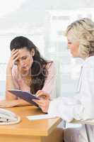 Female doctor discussing reports with patient