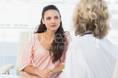 Female patient listening to doctor with concentration in medical