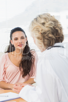 Female patient listening to doctor with concentration