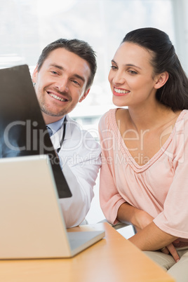 Male doctor explaining x-ray report to patient