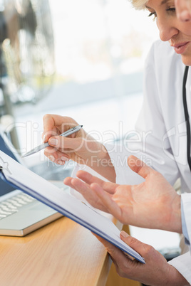 Close-up mid section of two doctors in meeting