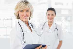 Portrait of a beautiful female doctor with clipboard