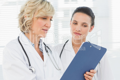 Two female doctors reading medical reports