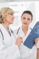 Two female doctors reading medical reports