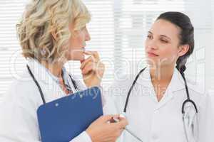 Two female doctors with medical reports