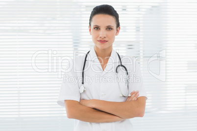 Beautiful female doctor standing with arms crossed Beautiful female doctor standing with arms crossed