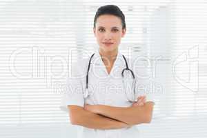 Beautiful female doctor standing with arms crossed