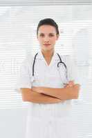 Beautiful female doctor standing with arms crossed