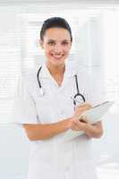 Portrait of a beautiful female doctor with clipboard