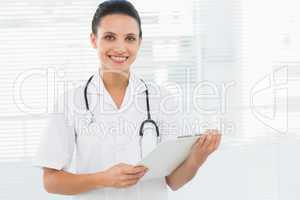 Portrait of a beautiful young female doctor with clipboard