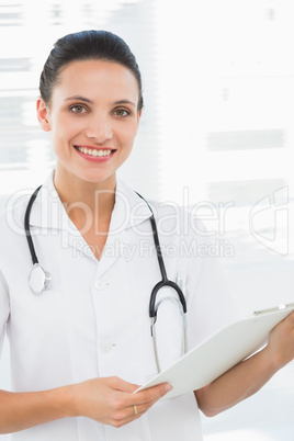 Portrait of a beautiful female doctor with clipboard