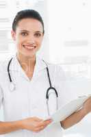 Portrait of a beautiful female doctor with clipboard