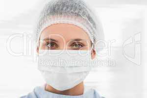 Female surgeon wearing surgical cap and mask