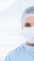 Female surgeon wearing surgical cap and mask