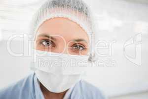 Female surgeon wearing surgical cap and mask