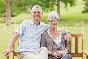 Senior couple sitting on bench at park