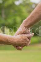 E lderly couple holding hands
