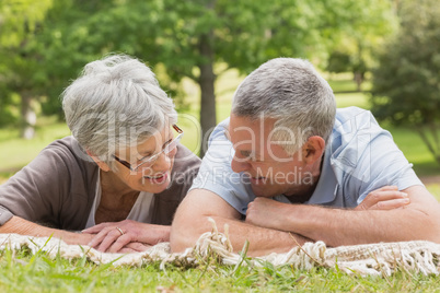 Senior couple lying at the park