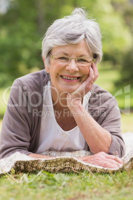 Close-up of a senior woman lying at park