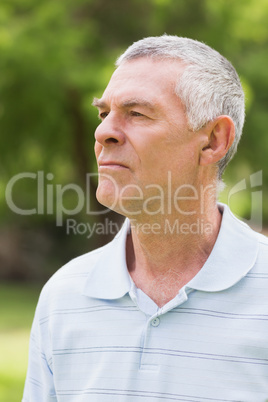 Close-up of a serious senior man at park Close-up of a serious senior man at park