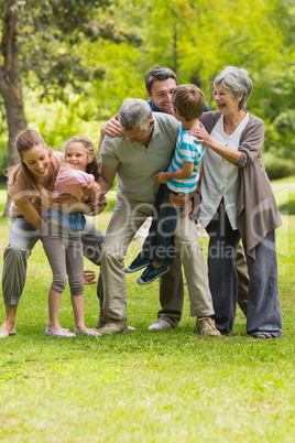 Extended family playing in park