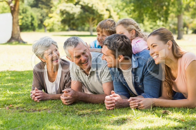 Extended family lying on grass in park