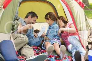 Family sitting in the tent at park