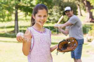 Father and daughter playing baseball