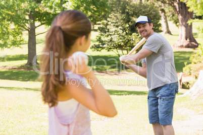 Father and daughter playing baseball