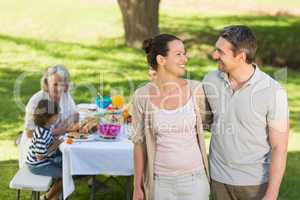 Couple with family dining at outdoor table