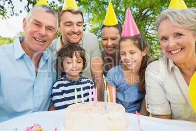 Family with cake outdoors