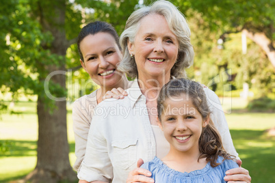 Woman with grandmother and granddaughter at park