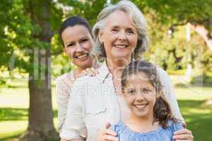 Woman with grandmother and granddaughter at park