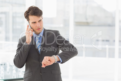 Businessman checking the time on the phone