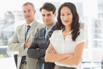 Business team standing in a row smiling at camera