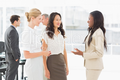 Businesswomen speaking together in conference room