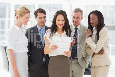 Business team looking at sheet of paper together