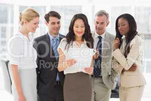 Business team looking at sheet of paper together