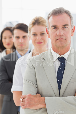 Business team standing in a line looking at camera