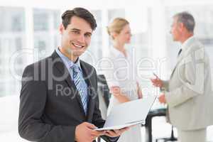 Businessman reading over a document smiling at camera